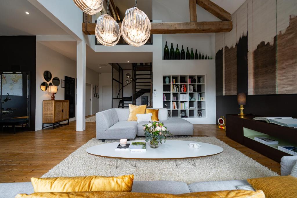 a living room with a couch and a table at Maison d'Hôtes "Les Bulles Dorées" in Rilly-la-Montagne