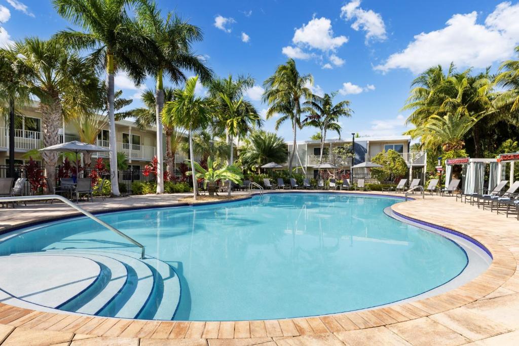 a swimming pool at a resort with palm trees at Fairfield Inn & Suites by Marriott Key West at The Keys Collection in Key West