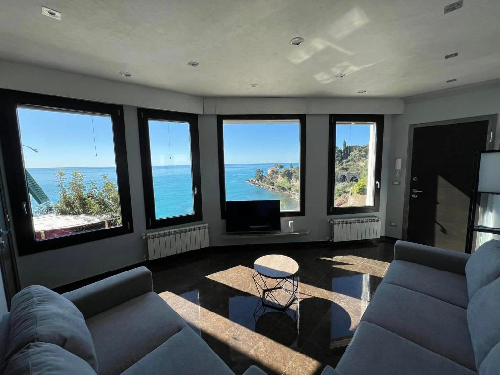 a living room with a view of the ocean at Appartamento un mare di fiori in Ventimiglia