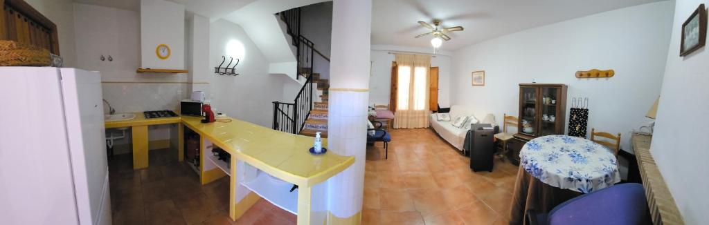 a kitchen and living room with a yellow counter top at Corralazo B in Calasparra