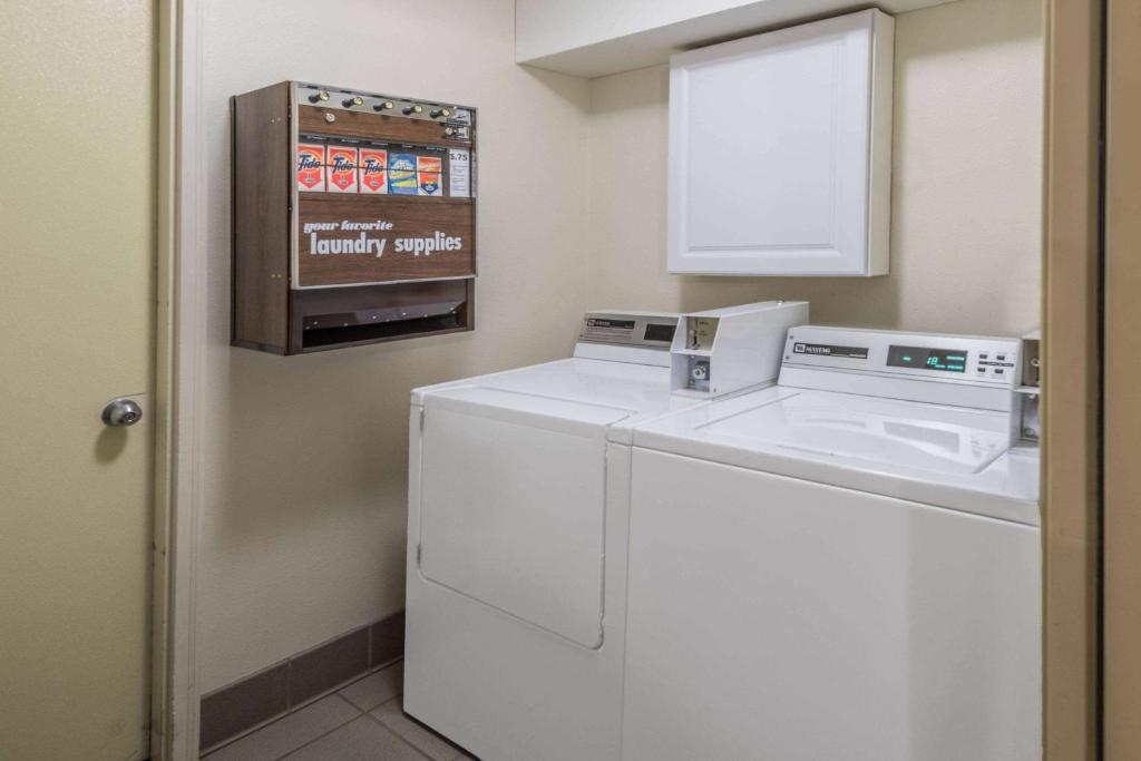 a laundry room with a washer and dryer at Days Inn by Wyndham Great Falls in Great Falls