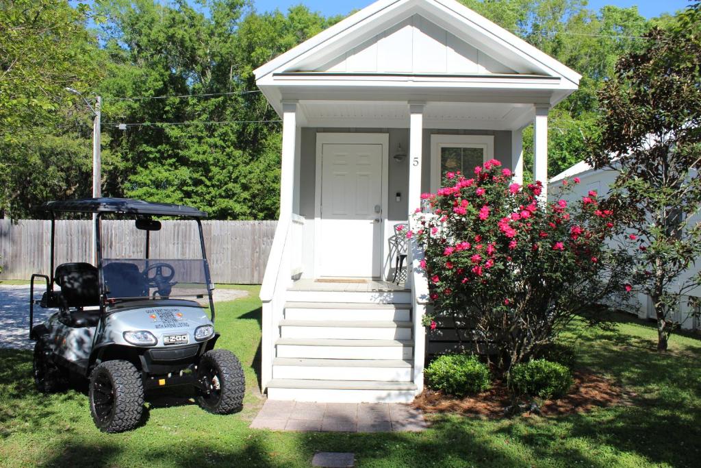 a tiny house with a golf cart parked in front of it at Best Cottage in Ocean Springs- GOLF CART INCLUDED!!! in Ocean Springs