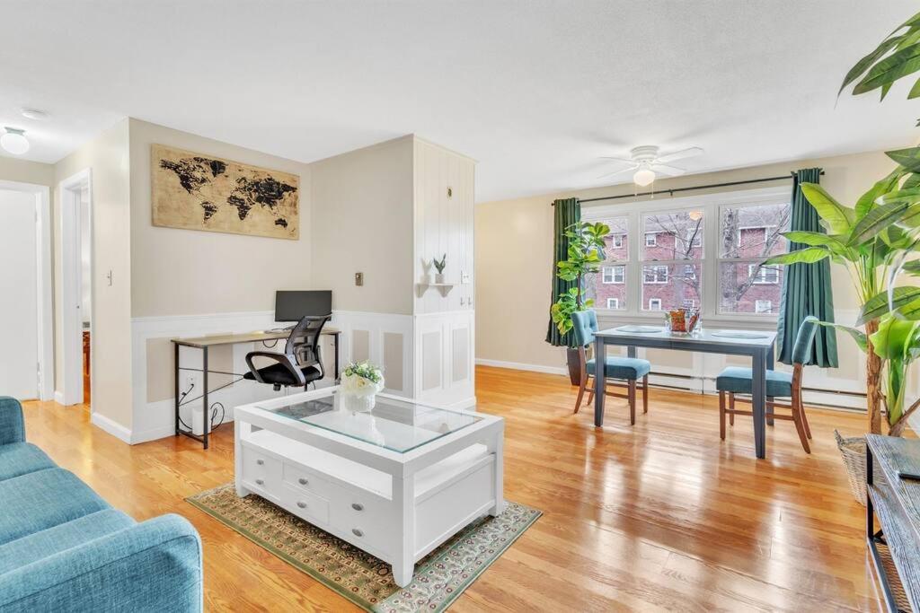 a living room with a blue couch and a table at Central Chic Crib in Manchester