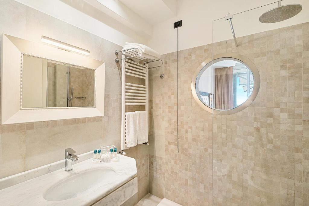 a bathroom with a sink and a mirror at Hotel Excelsior in Marina di Massa
