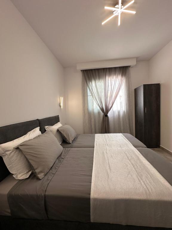 a bedroom with a large bed and a window at Stegna Sea & Sun in Archangelos