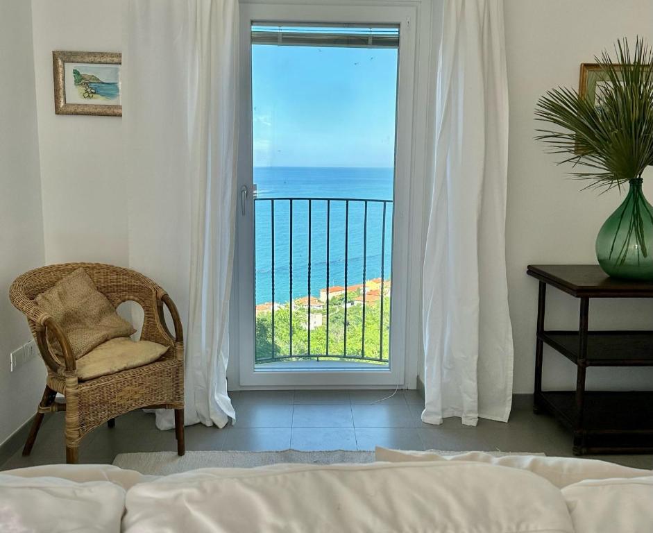 een slaapkamer met uitzicht op de oceaan door een deur bij LA CASA SUL MARE in San Vito Chietino