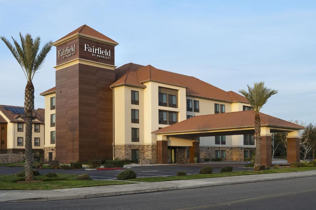 a hotel with a sign on top of a building at Fairfield by Marriott Inn & Suites Fresno Riverpark in Fresno