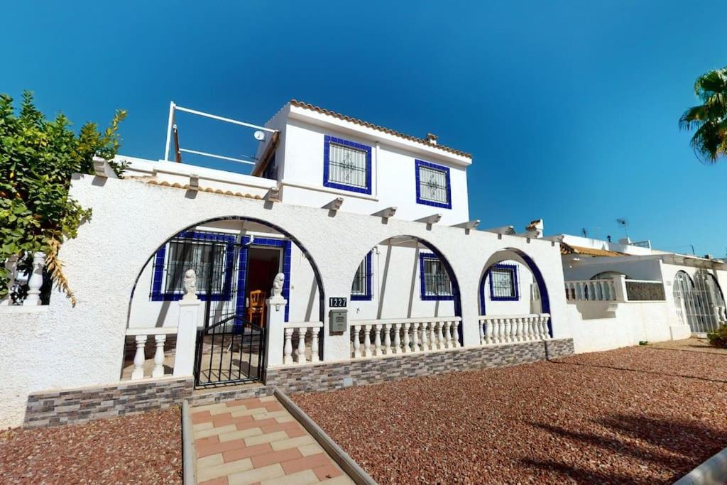 a white house with an archway in front of it at Casa 1227 in Los Alcázares