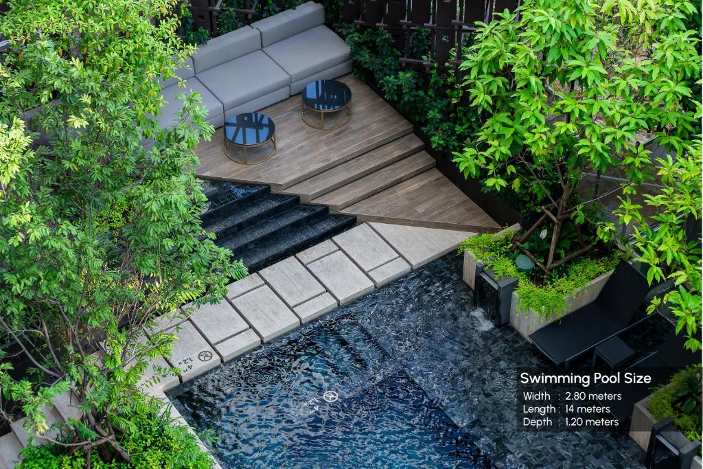 An overhead view of the pool, deck and a shaded seating nook.