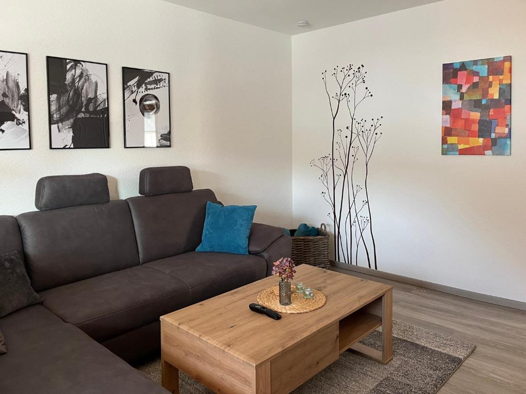 a living room with a couch and a coffee table at Ferienwohnung TAUNUSIDYLLE 