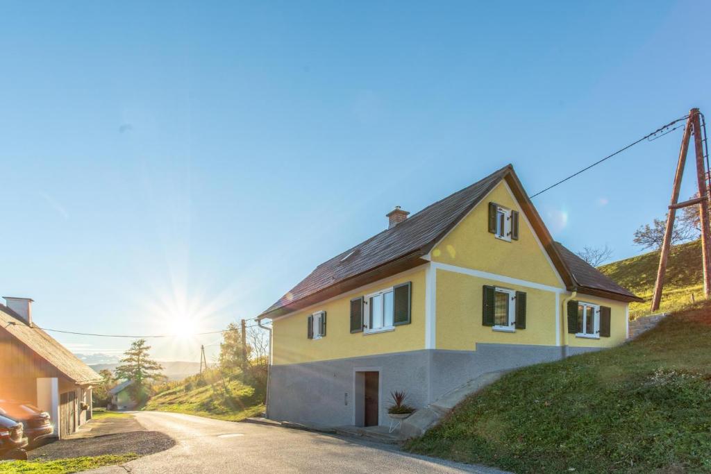 a yellow house on the side of a road at Haus Edler in Gleinstätten