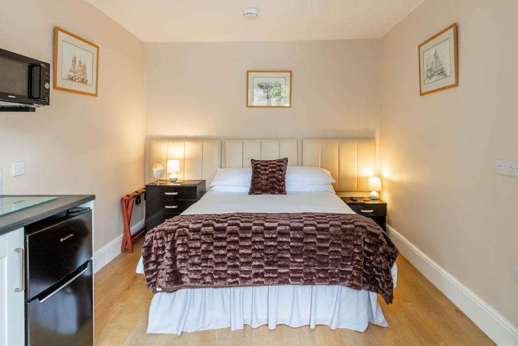 a bedroom with a bed and two night stands at Roger Ground Guest House - with Onsite Car Parking in Windermere