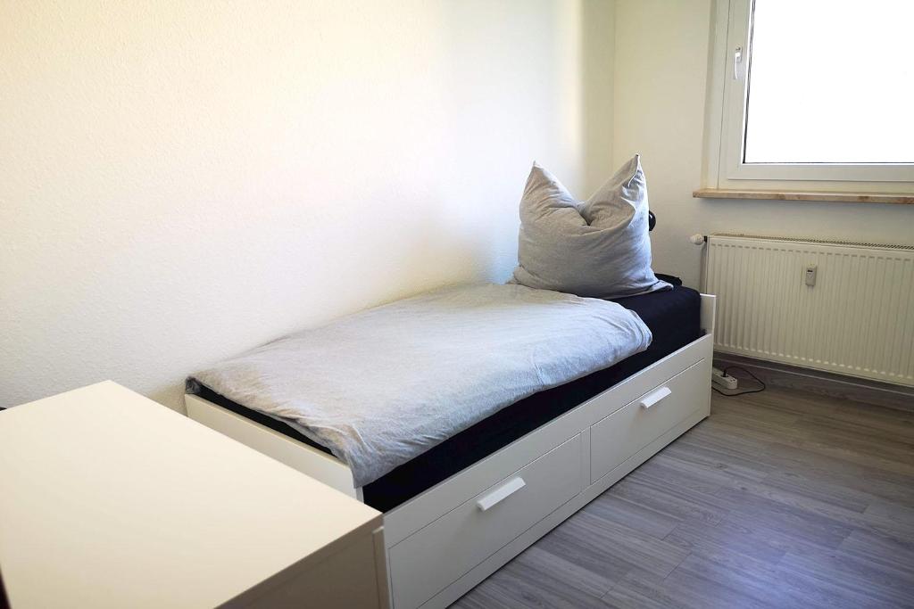 a bed with a pillow on top of it in a room at Cozy Apartment in Dessau-Roßlau in Dessau