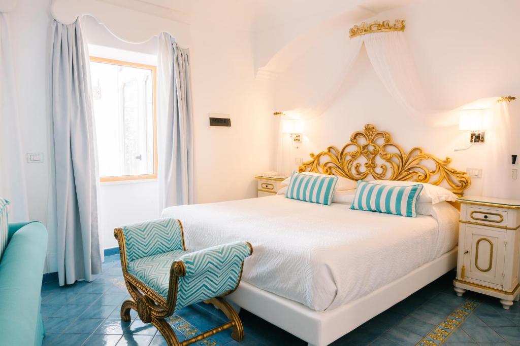 Postel nebo postele na pokoji v ubytování Hotel Conca d'Oro
