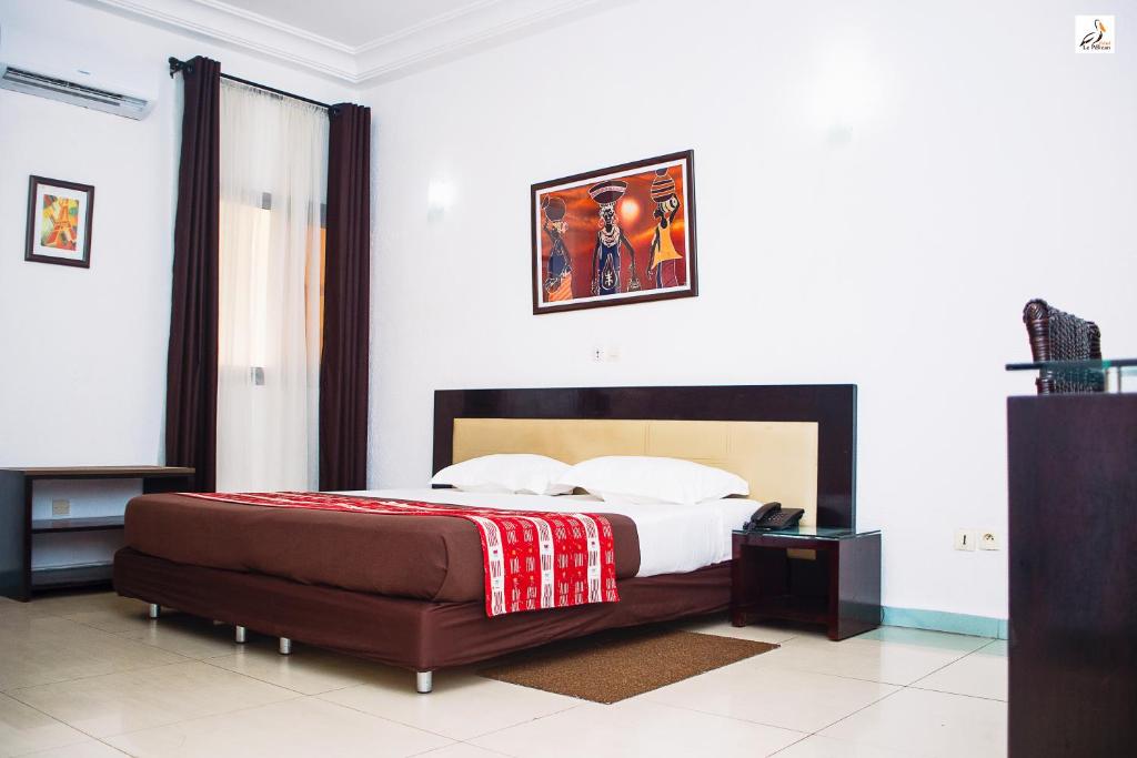 Postel nebo postele na pokoji v ubytování Hotel le Pelican