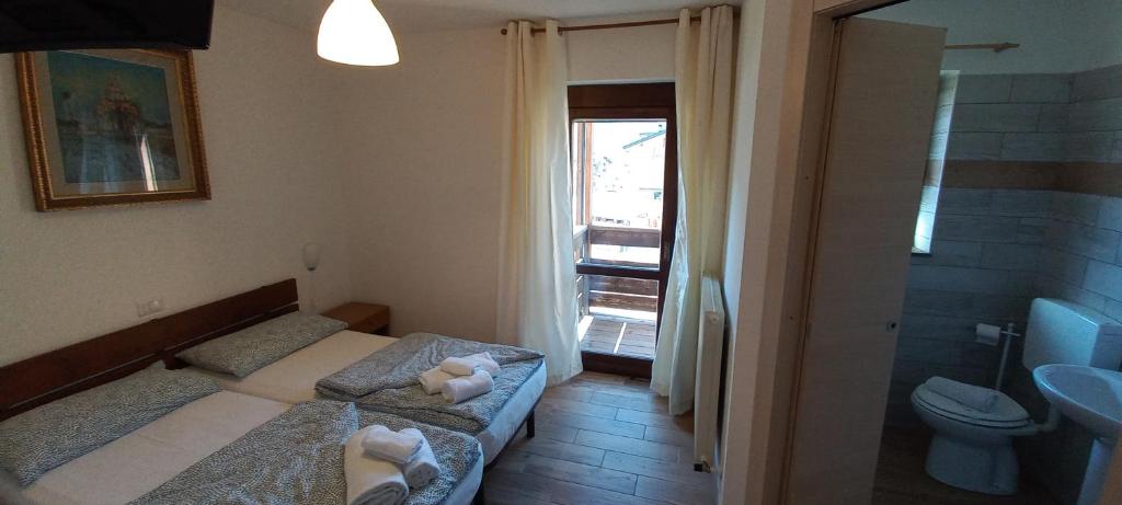 Postel nebo postele na pokoji v ubytování Hotel Salgetti