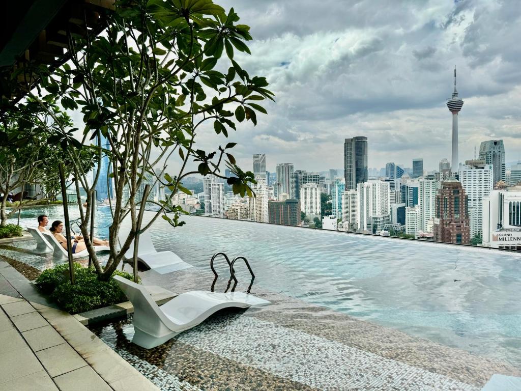 a swimming pool with a view of a city at Axon Residence By TS in Kuala Lumpur