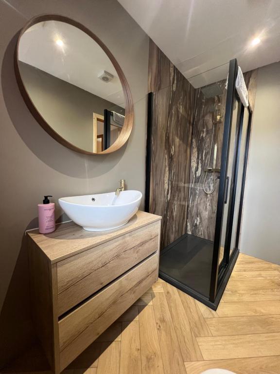 a bathroom with a sink and a mirror at Nevis Croft Apartment 3 in Fort William