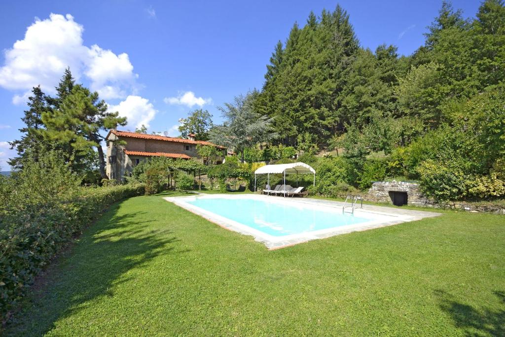 a swimming pool in a yard next to a house at Villa Magnolia in Cortona