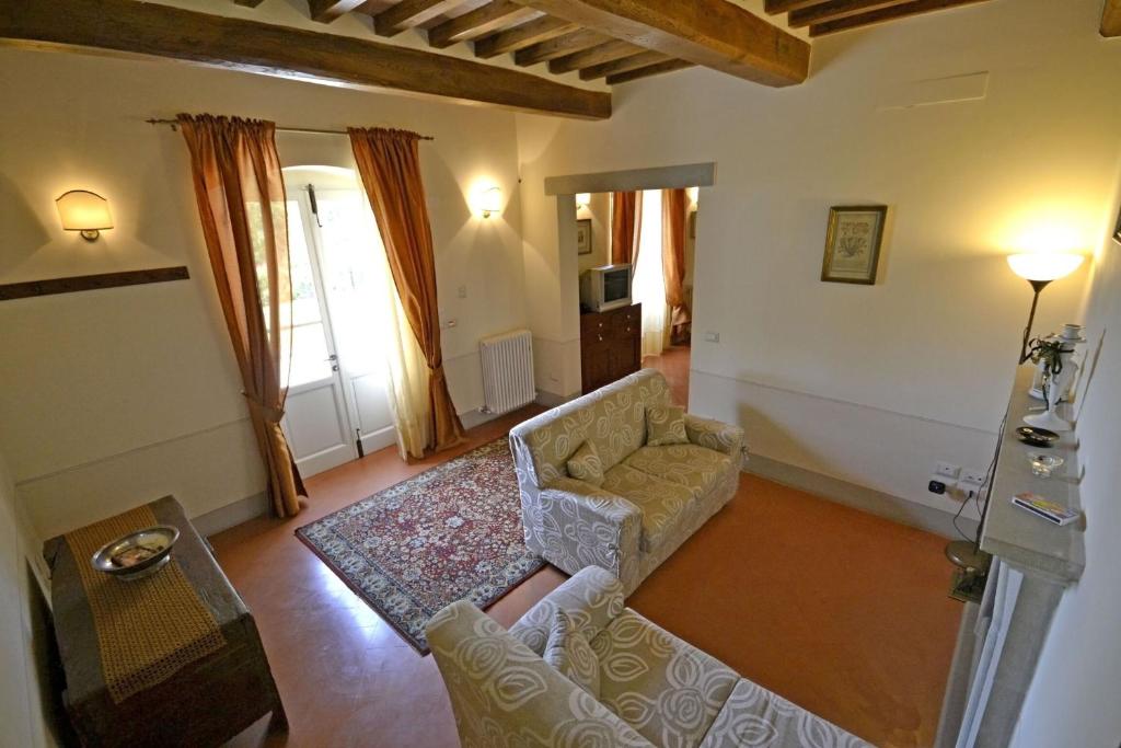 salon z kanapą i stołem w obiekcie Villa Il Palazzone w mieście Cortona