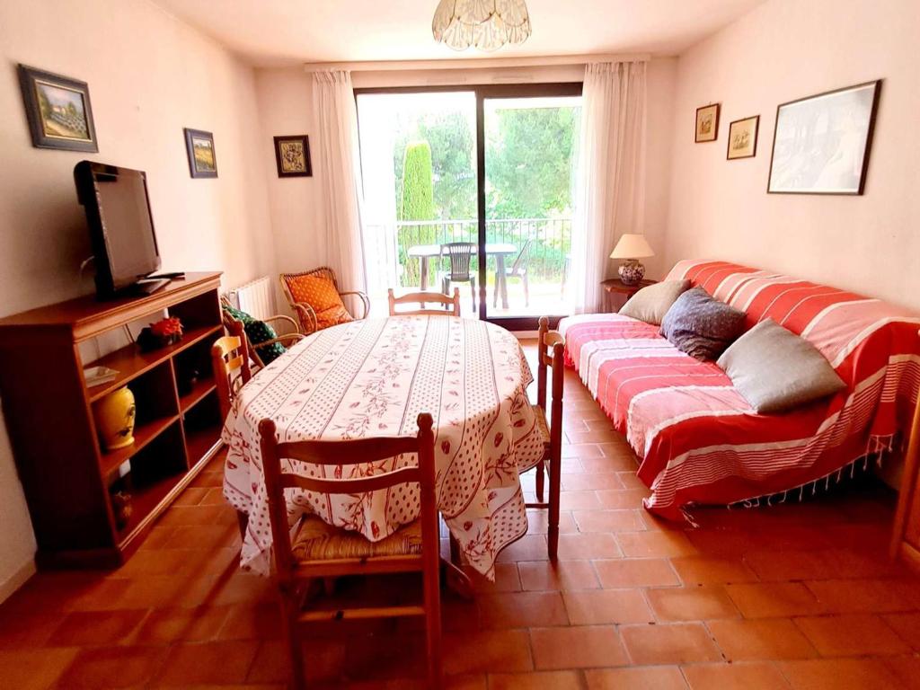 a living room with a table and a couch at Appartement Six-Fours-les-Plages, 3 pièces, 6 personnes - FR-1-316-122 in Six-Fours-les-Plages