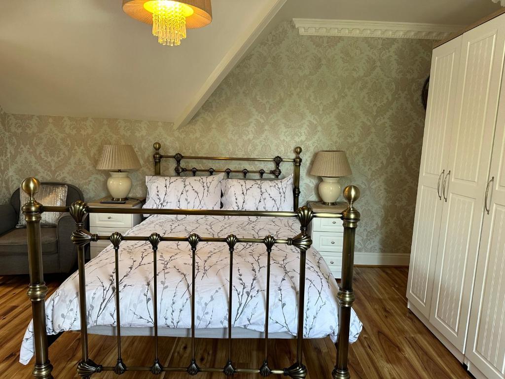 a bedroom with a bed with two lamps and a chandelier at ElMurrs in Bournemouth