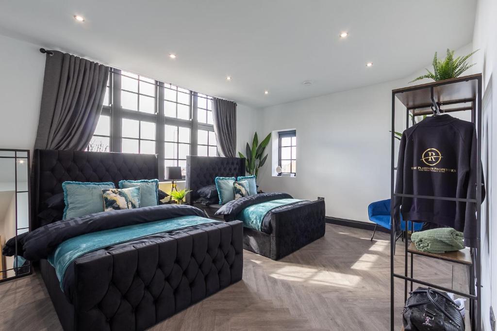 a bedroom with two beds and a couch at 4 Beds 2 Bath Stunning Apartment On Street Parking in Brighton & Hove