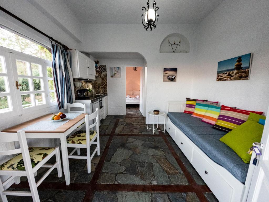 a room with a couch and a table and a kitchen at Tea & Sea Apts in Anissaras