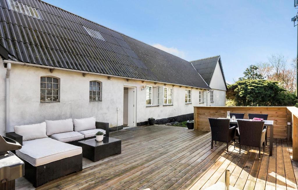 a patio with a couch and chairs on a wooden deck at Nice Apartment In Gilleleje in Gilleleje