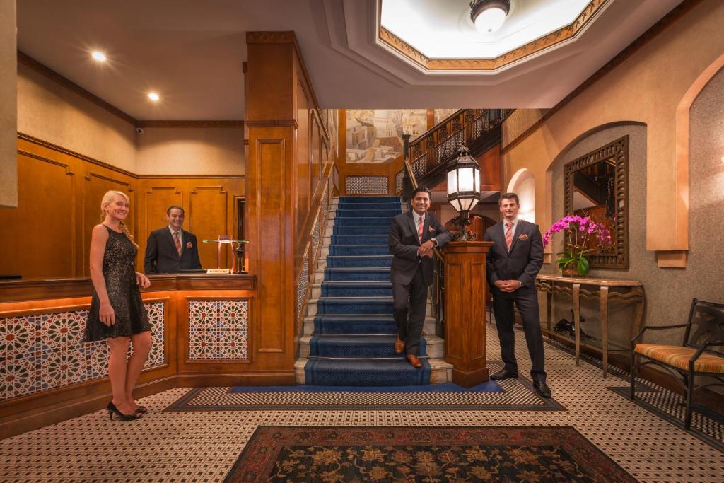 a group of people walking up a staircase in a building at Casablanca Hotel by Library Hotel Collection in New York