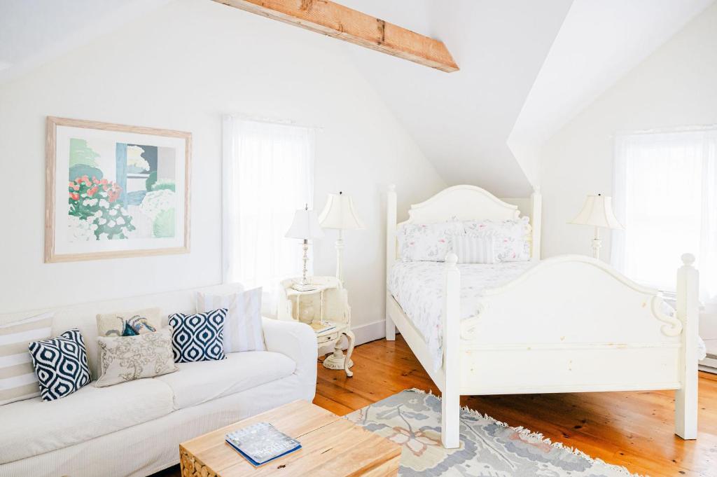 a white living room with a bed and a couch at Adorable guesthouse with stunning views close to beach in Nantucket