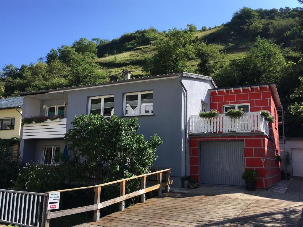 a house with a hill in the background at Appartement in Pommern mit Garten und Grill in Pommern