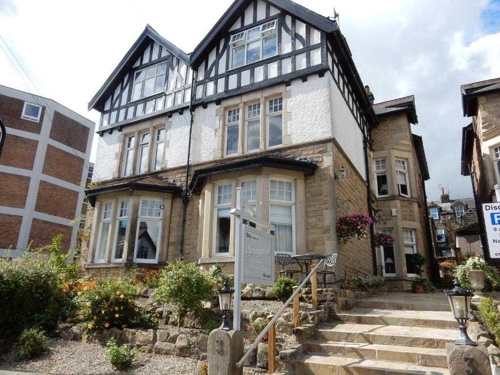 an old house with a sign in front of it at Springdale Guest House in Harrogate