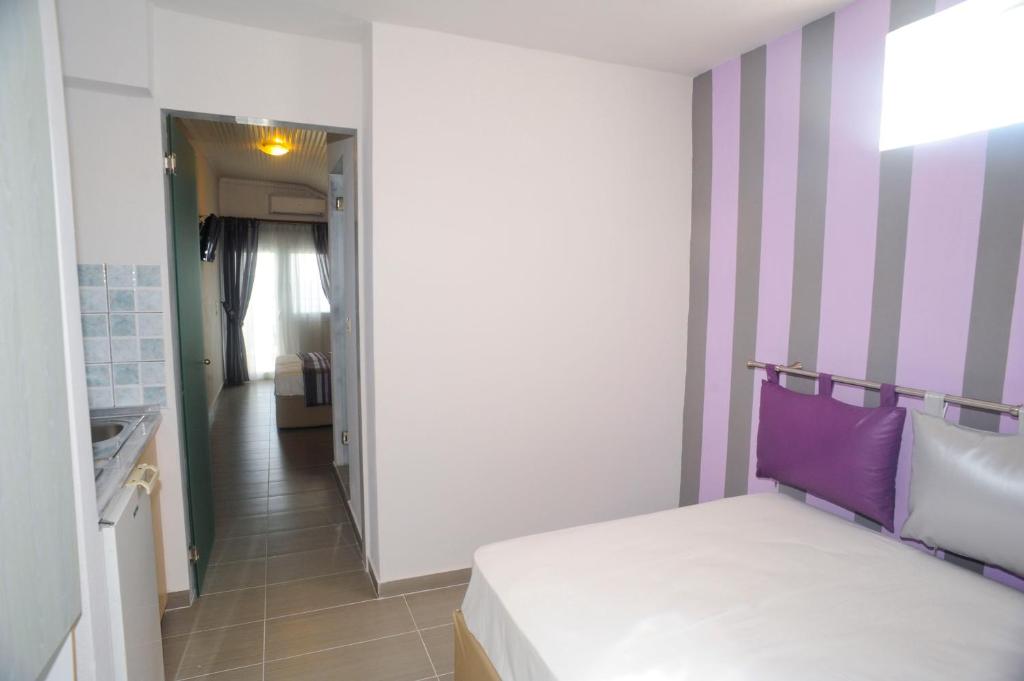 Łóżko lub łóżka w pokoju w obiekcie Hotel Asterias