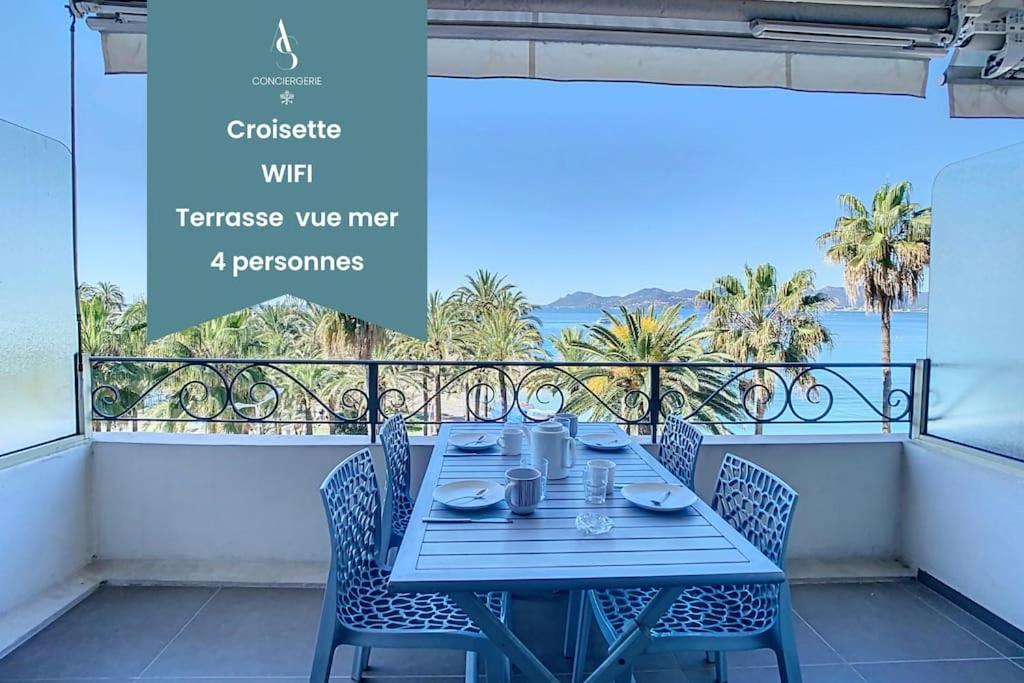 a table on a balcony with a view of the ocean at Le Croisette I - 4 pers - Front de mer - Cannes in Cannes