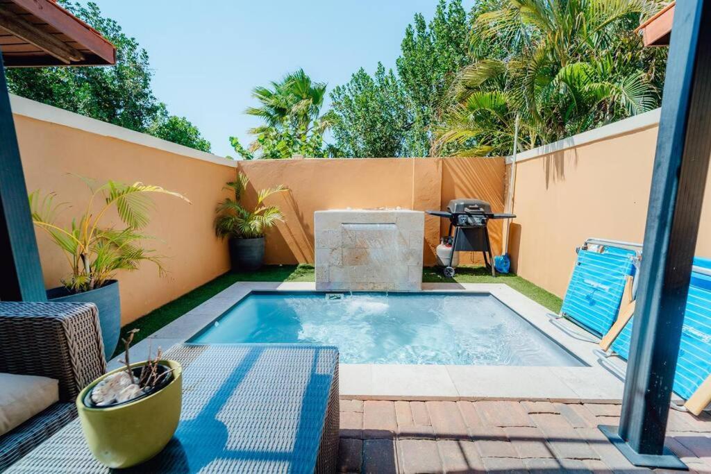 a small swimming pool in a backyard with a fence at Gold coast beautiful house with private pool in Palm-Eagle Beach