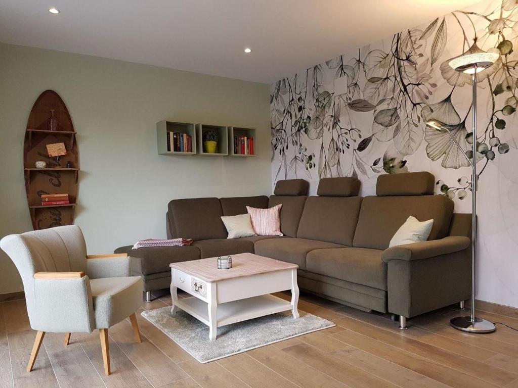 a living room with a couch and a table at Haferspieker in Mittelangeln