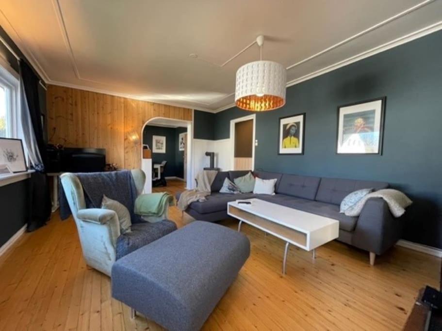 a living room with a couch and a table at Large, central and quiet apartment. in Stavanger