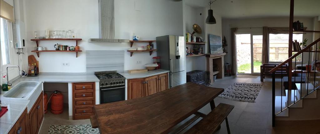 a kitchen with a wooden table and a sink at Casa Rural Sierra Guadalcanal in Guadalcanal