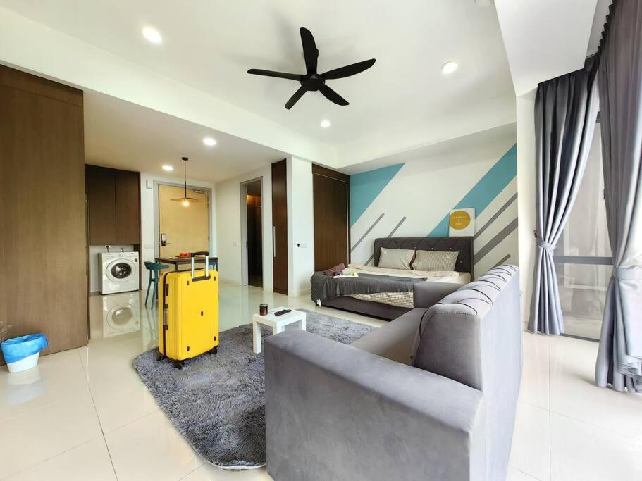 a living room with a couch and a ceiling fan at A2305 Grand Medini Studio 100mbps Netflix By STAY in Nusajaya