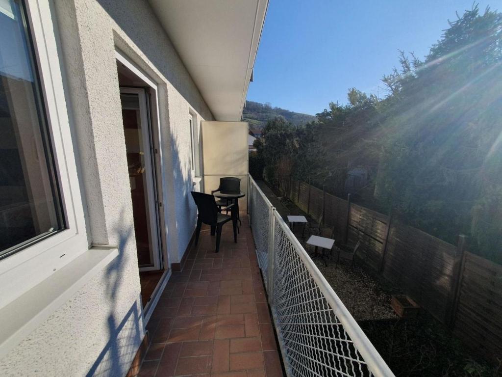 a balcony of a house with a table and chairs at 17 Apartments und 2 Suiten in Zwingenberg