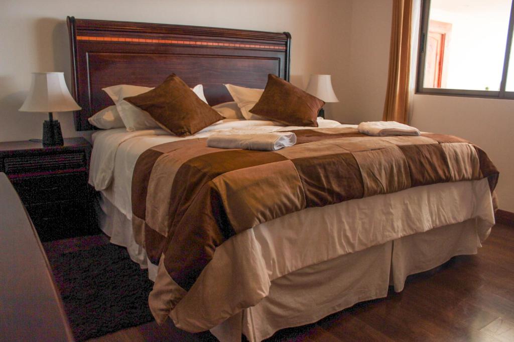 Postel nebo postele na pokoji v ubytování HOTEL QUINTA ESTACIÓN