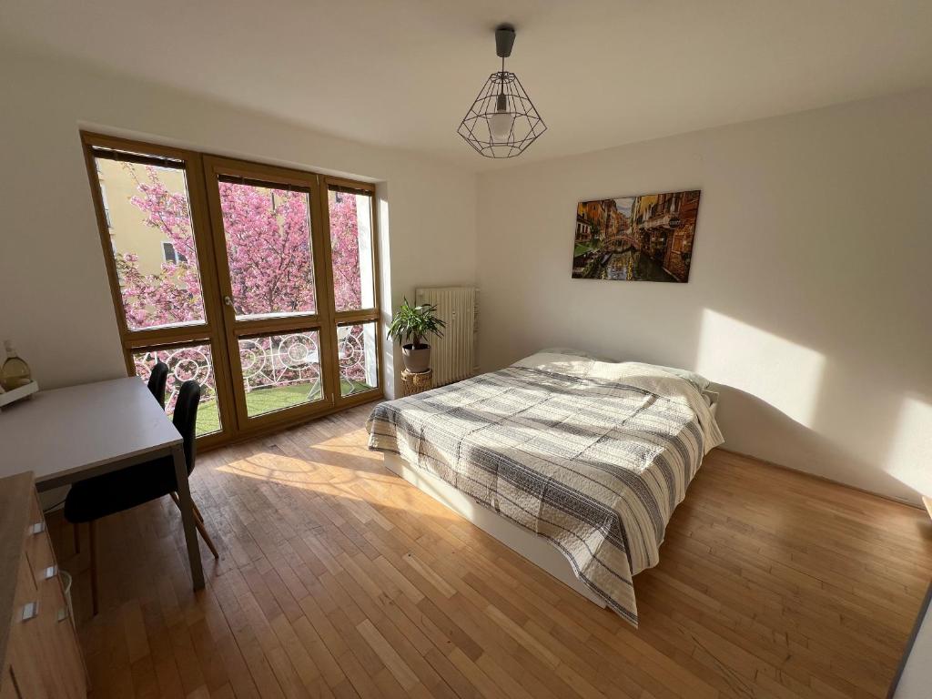 a bedroom with a bed and a desk and a window at Apartmán v centre in Banská Bystrica