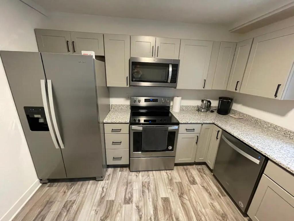 a kitchen with stainless steel appliances and white cabinets at 2 Bedroom Apartment, Walk To Mayo, Free Parking in Rochester