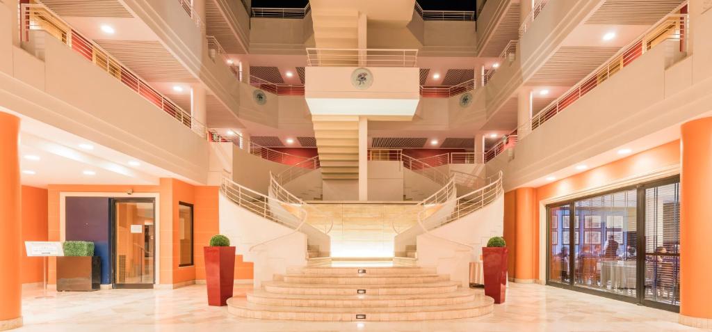 a large staircase in a building with a spiral stair case at Caesar's Hotel in Cagliari