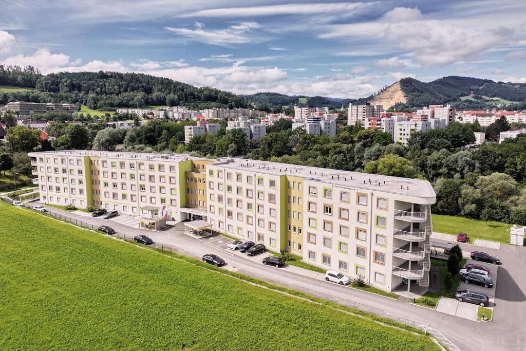 an aerial view of a building in a city at I AM HOTEL im Living Campus in Leoben