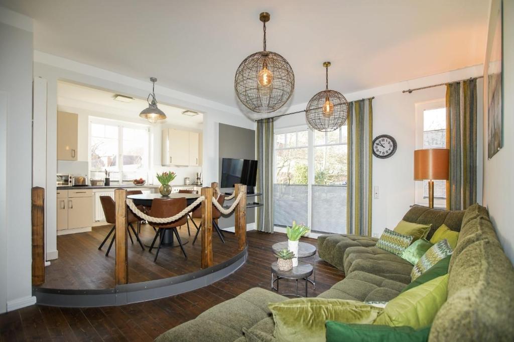a living room with a couch and a table at FeWo Lina in Borkum