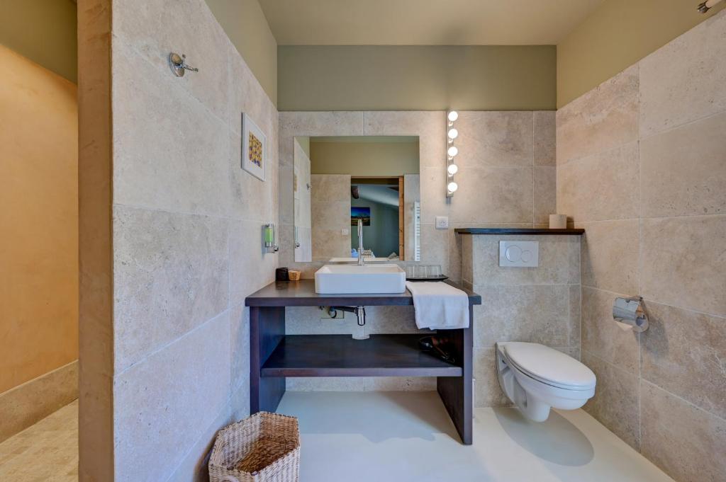 a bathroom with a sink and a toilet at Hostellerie Le Paradou in Lourmarin