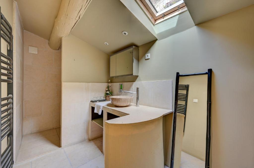 a kitchen with a sink and a counter top at Hostellerie Le Paradou in Lourmarin