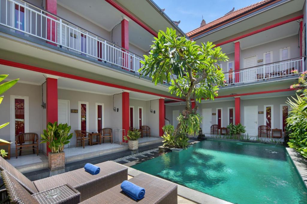 a pool in the courtyard of a villa at Angkul Angkul Beach Inn Kuta by Kamara in Kuta